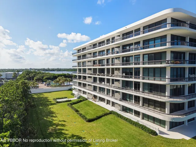 a view of a large building with a big yard and large trees