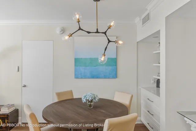 a dining room with a table and chairs