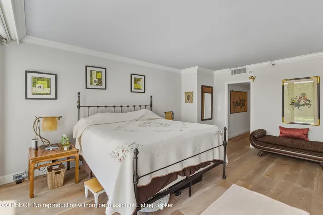 a spacious bedroom with a bed and dresser