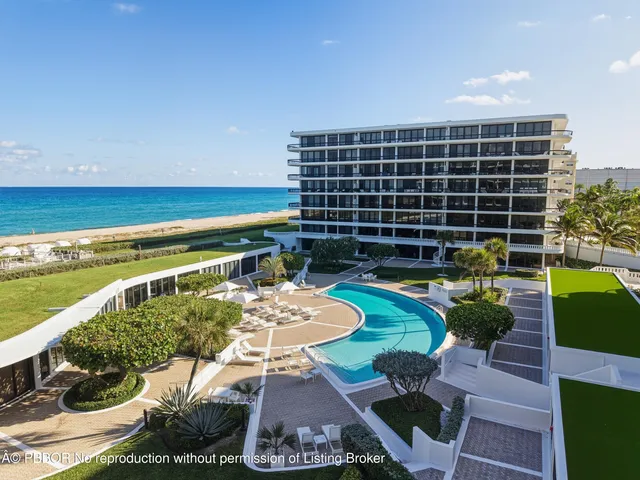 a view of a swimming pool with furniture