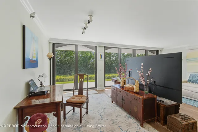 a living room with furniture and a floor to ceiling window