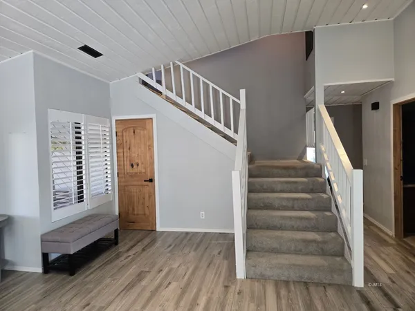a view of entryway with wooden floor and stairs
