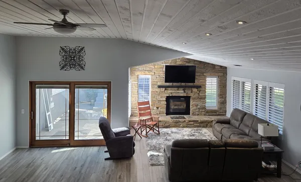 a living room with fireplace furniture and a flat screen tv