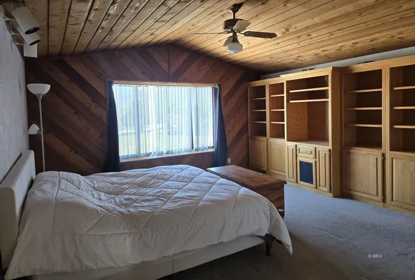 a bedroom with a bed closet and window