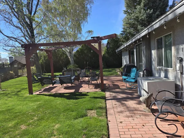 a view of a backyard with sitting area