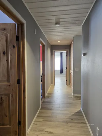a view of hallway with wooden floor
