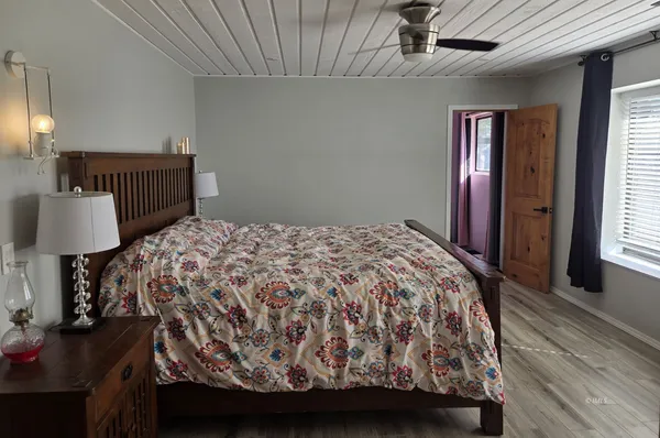 a bedroom with a bed and a lamp on table