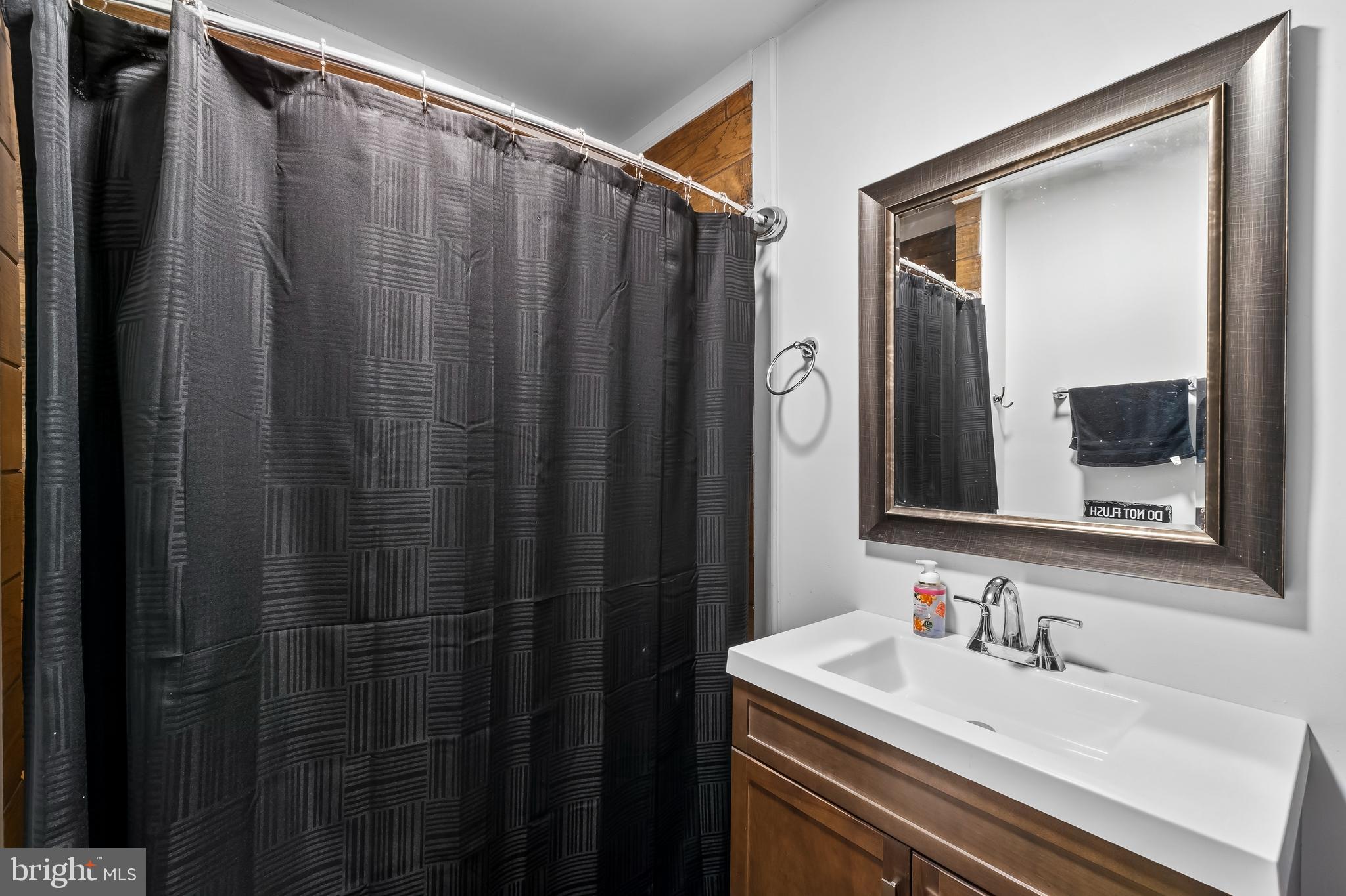 708 South 3rd Street Millville, NJ 08332 - Photo 13 of 33 a bathroom with a sink and a mirror