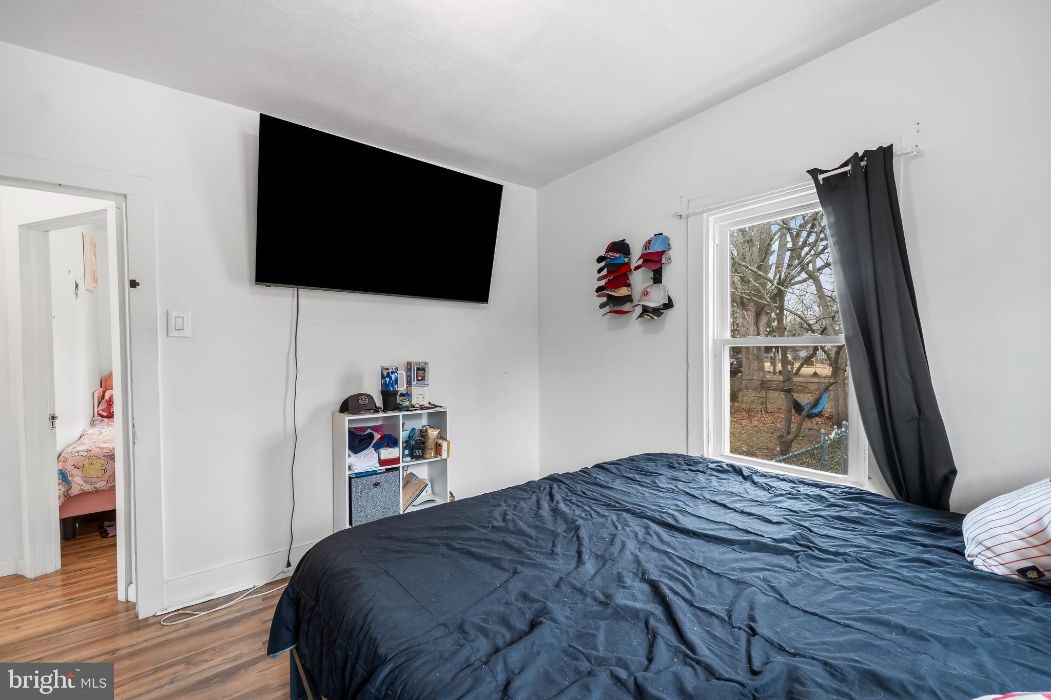 708 South 3rd Street Millville, NJ 08332 - Photo 16 of 33 a bedroom with a bed and a flat screen tv
