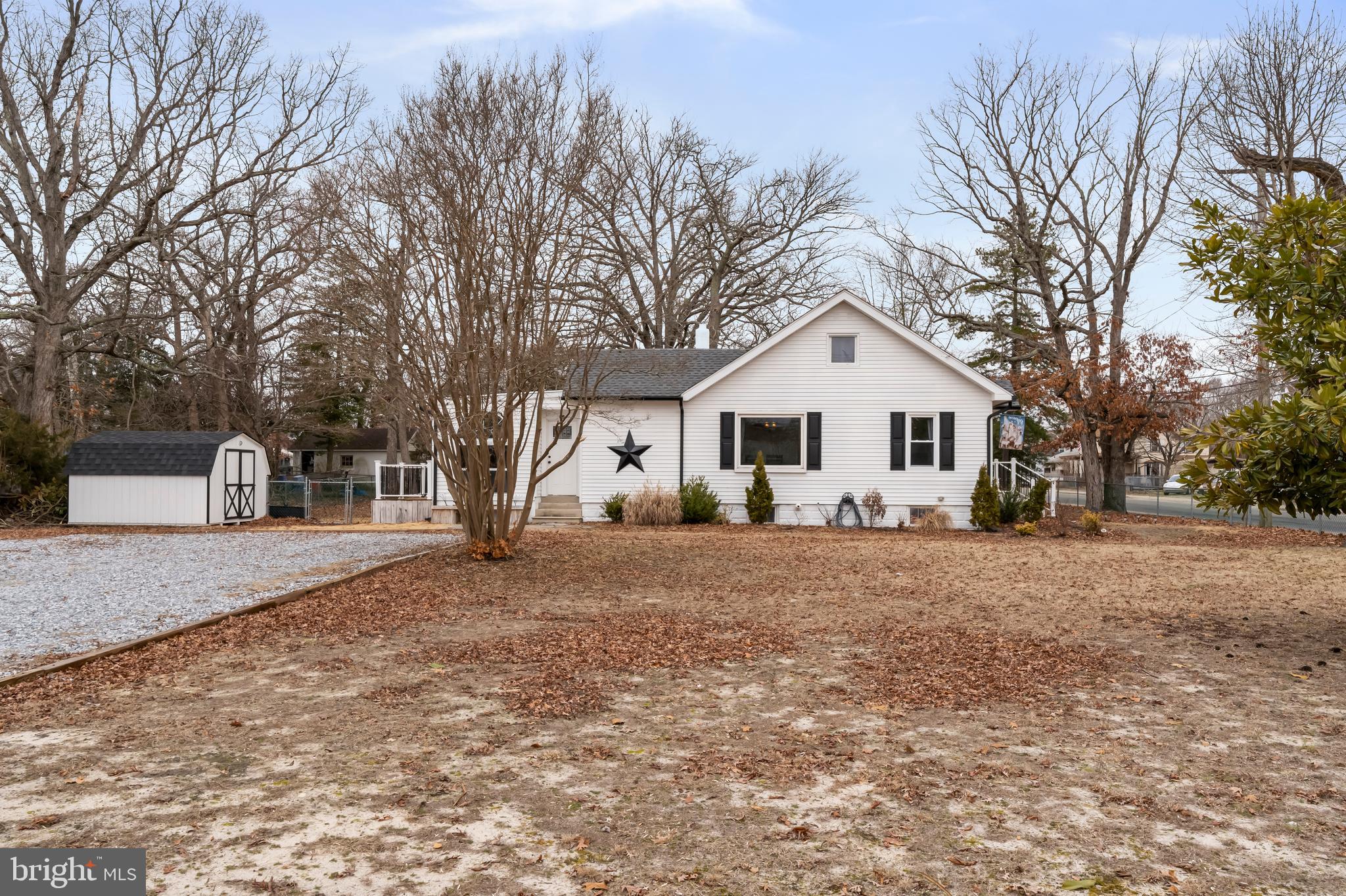 708 South 3rd Street Millville, NJ 08332 - Photo 27 of 33 a view of a white house with a yard and large tree