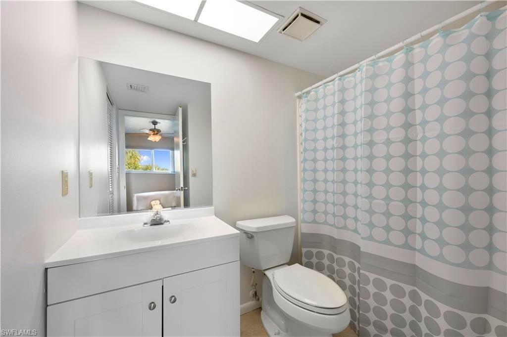 1018 Manatee Road, Unit E302 Naples, FL 34114 - Photo 12 of 19 Bathroom with vanity and curtained shower