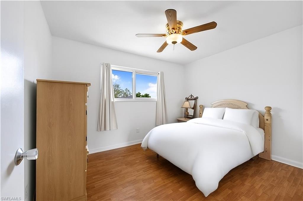 1018 Manatee Road, Unit E302 Naples, FL 34114 - Photo 13 of 19 Bedroom featuring wood finished floors and a ceiling fan