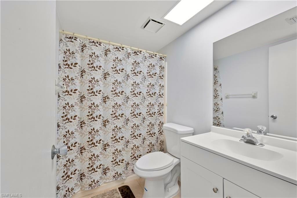 1018 Manatee Road, Unit E302 Naples, FL 34114 - Photo 14 of 19 Bathroom with vanity and curtained shower