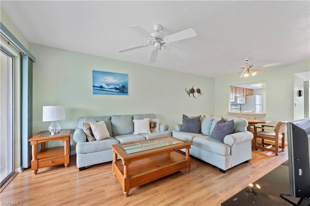 1018 Manatee Road, Unit E302 Naples, FL 34114 - Photo 3 of 19 Living room with a ceiling fan and light wood-style flooring