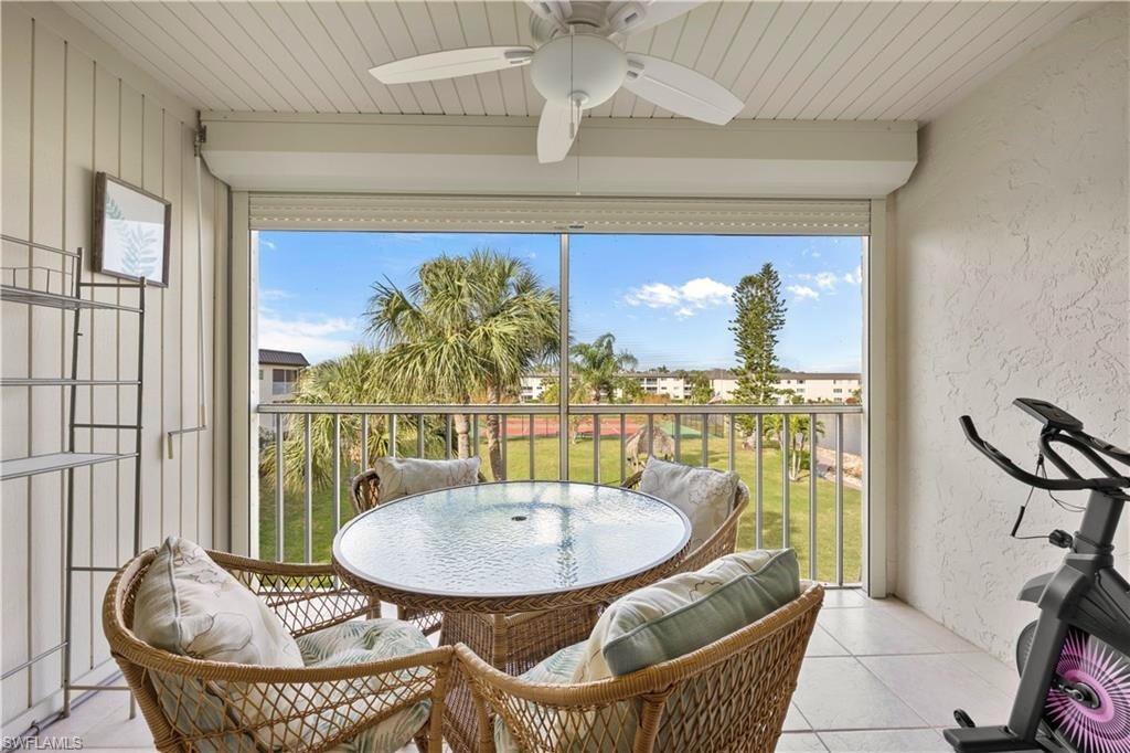 1018 Manatee Road, Unit E302 Naples, FL 34114 - Photo 8 of 19 Balcony with ceiling fan and outdoor dining space