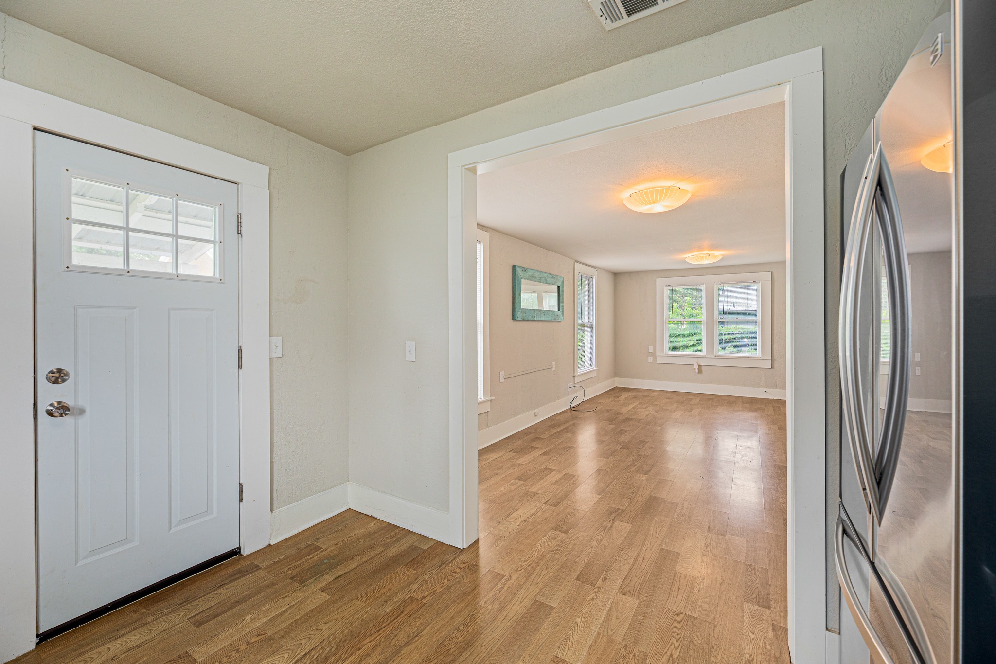 322 Blanco Avenue Luling, TX 78648 - Photo 10 of 20 Natural light illuminates rich hardwood-style flooring, guiding you through this inviting living space.