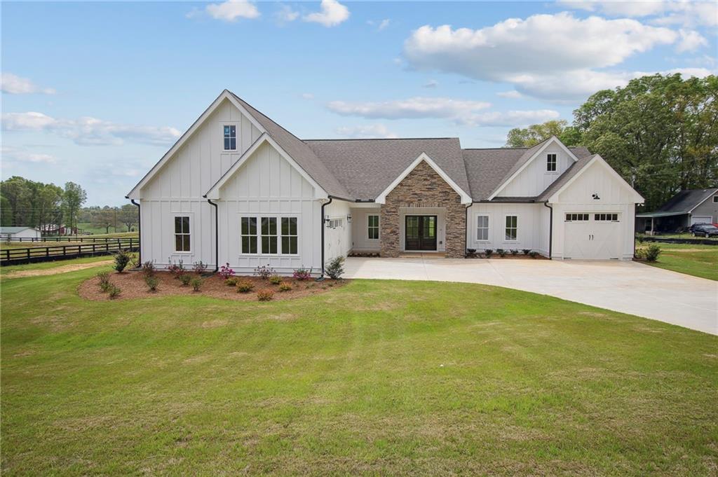 6120 Millwood Road Cumming, GA 30041 - Photo 1 of 1 a view of a house with a big yard and large trees