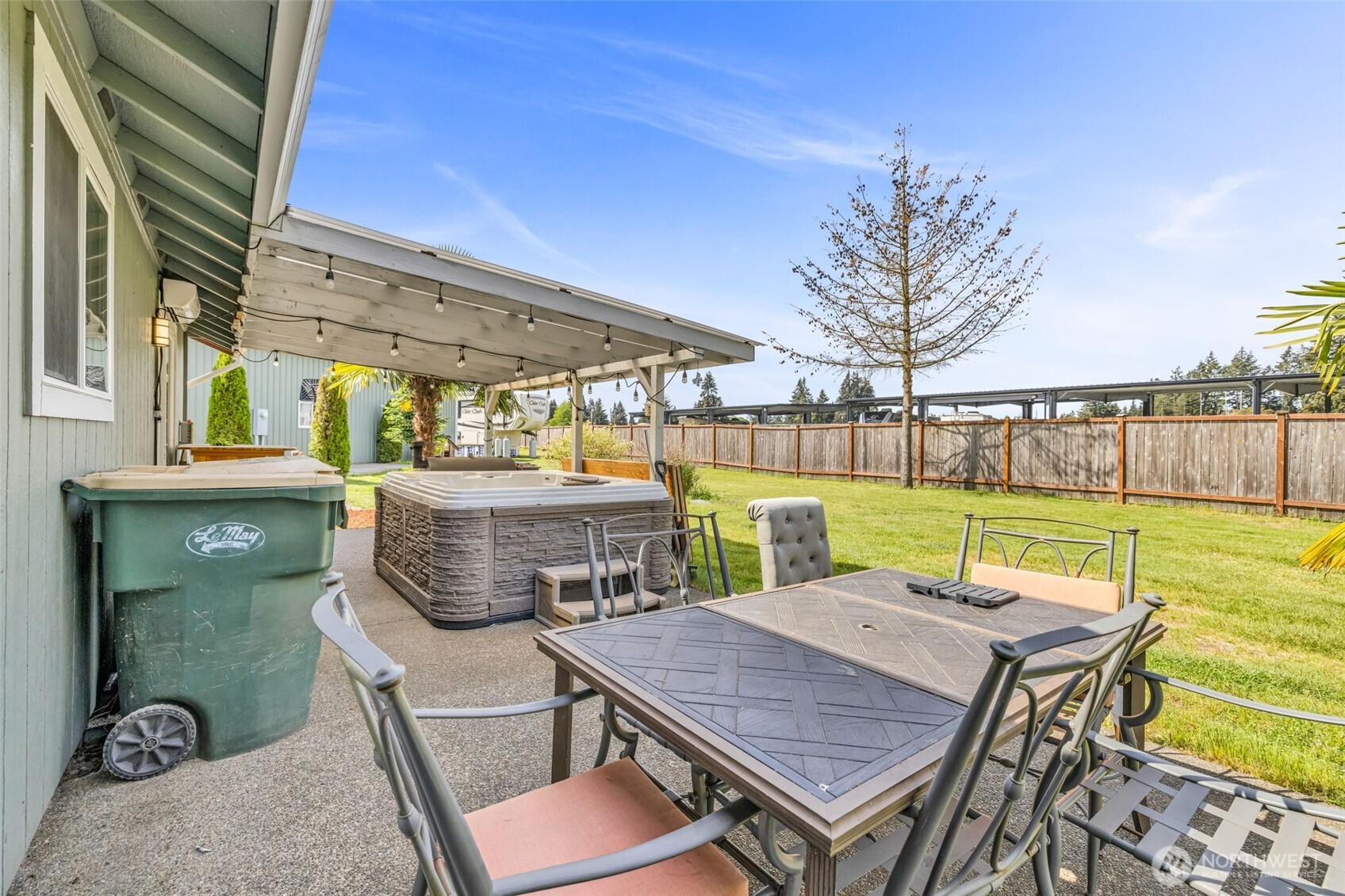 10313 School Land Road Southwest Rochester, WA 98579 - Photo 8 of 40 a view of a chairs and table in patio with a lake view