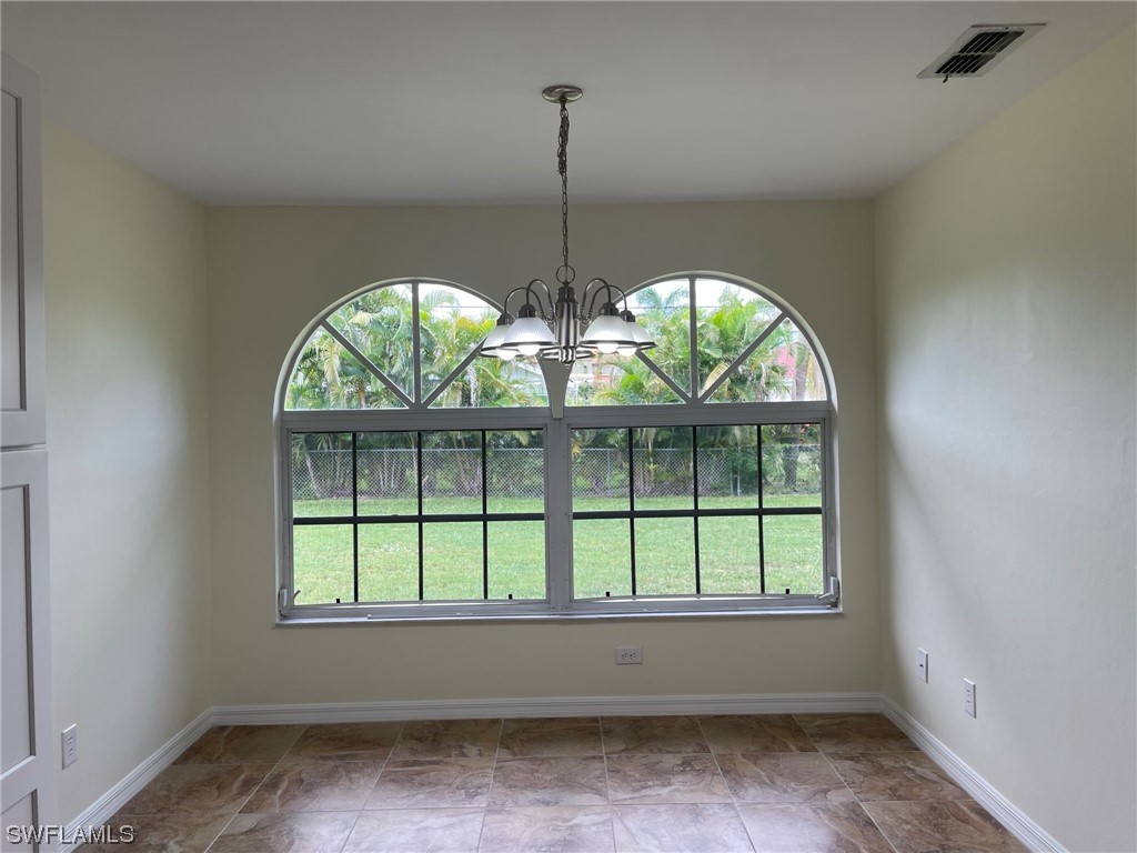 5727 Rose Garden Road, Unit B Cape Coral, FL 33914 - Photo 14 of 26 an empty room with windows and outdoor view