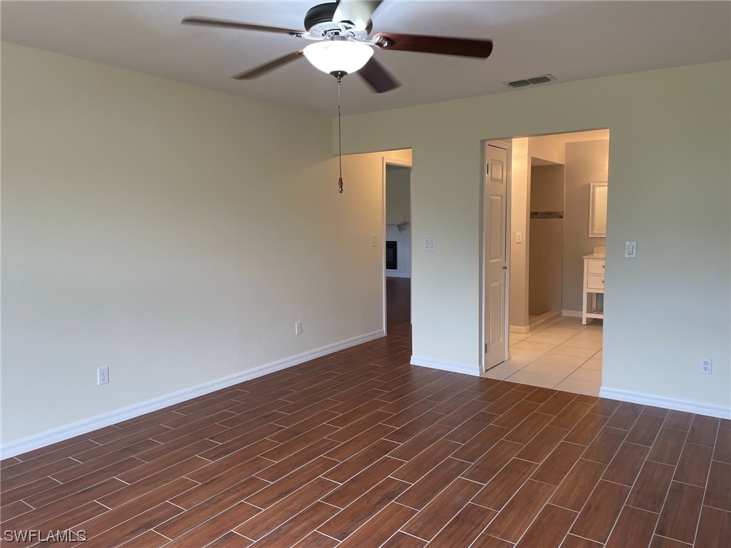 5727 Rose Garden Road, Unit B Cape Coral, FL 33914 - Photo 16 of 26 a view of an empty room with wooden floor