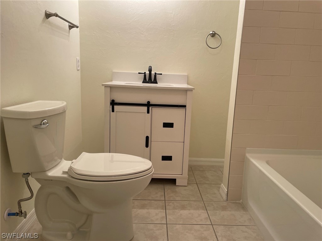 5727 Rose Garden Road, Unit B Cape Coral, FL 33914 - Photo 9 of 26 a bathroom with a sink a toilet and shower