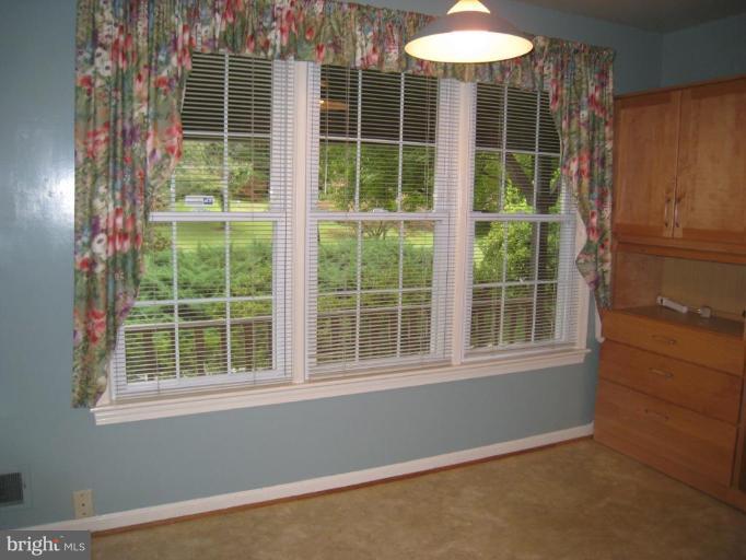 12912 Ruxton Road Silver Spring, MD 20904 - Photo 6 of 10 a view of an empty room with a window and balcony