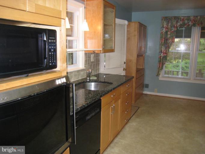 12912 Ruxton Road Silver Spring, MD 20904 - Photo 8 of 10 a kitchen with granite countertop a sink and a window