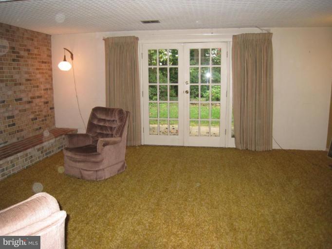 12912 Ruxton Road Silver Spring, MD 20904 - Photo 10 of 10 a room with furniture and a window
