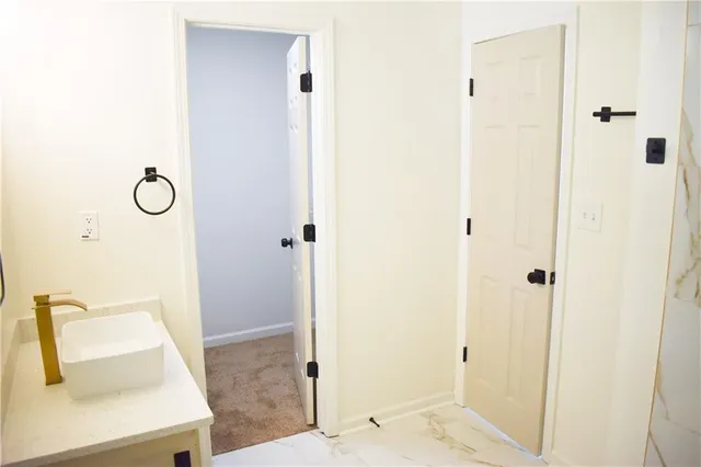 a bathroom with a sink a mirror and shower