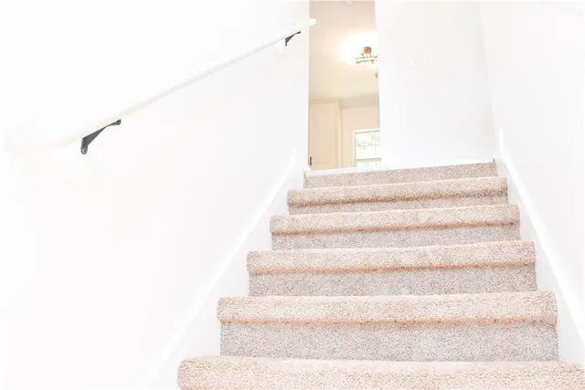 a view of staircase with white walls