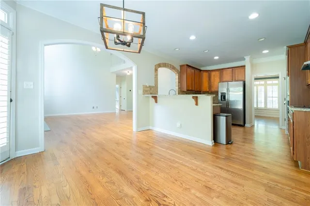 a kitchen with stainless steel appliances granite countertop a refrigerator and a sink