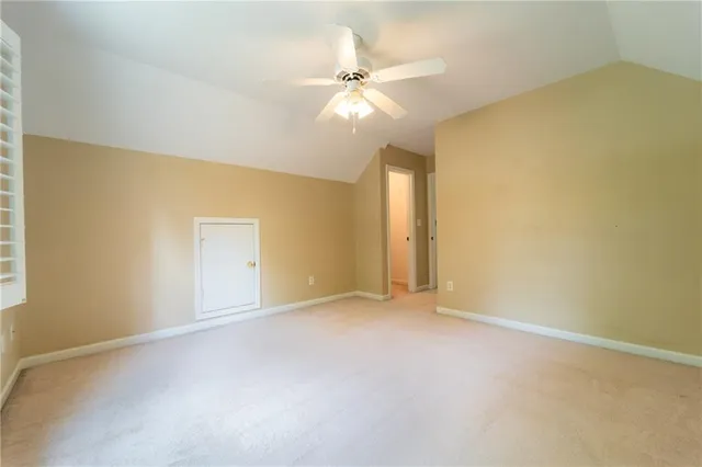 a bathroom with a granite countertop bathtub shower sink vanity mirror and toilet