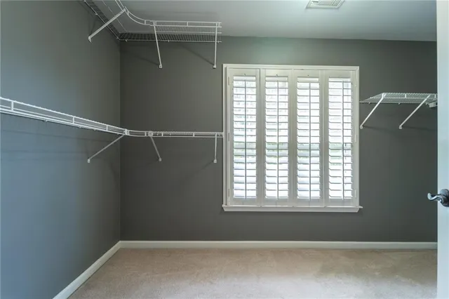 a view of a room with rack on the wall and a window