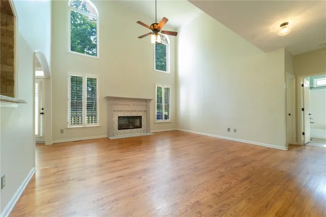 a view of a livingroom with wooden floor and a fireplace