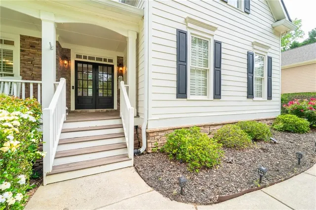 a view of a house with swimming pool and sitting area