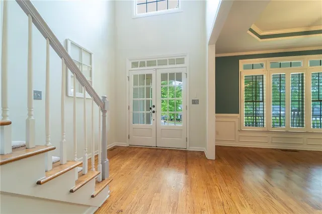 a view of entryway and hall with wooden floor
