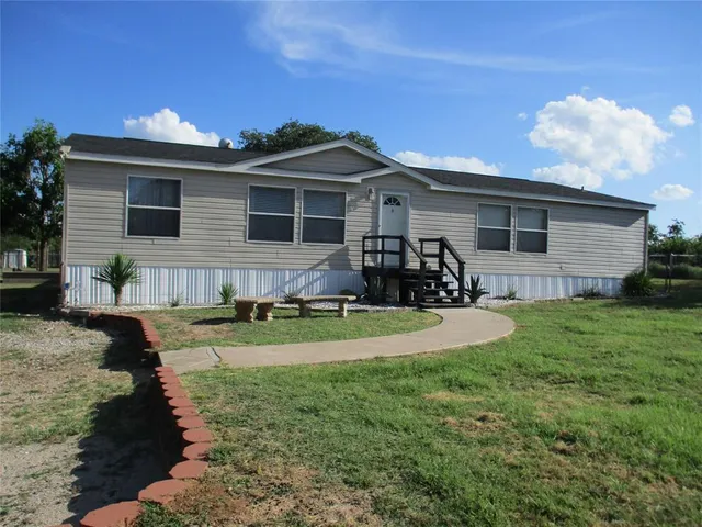 a front view of house with yard and outdoor seating