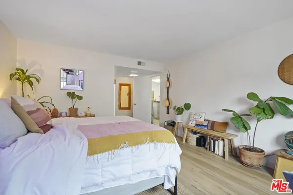 a bedroom with a bed table and a couch