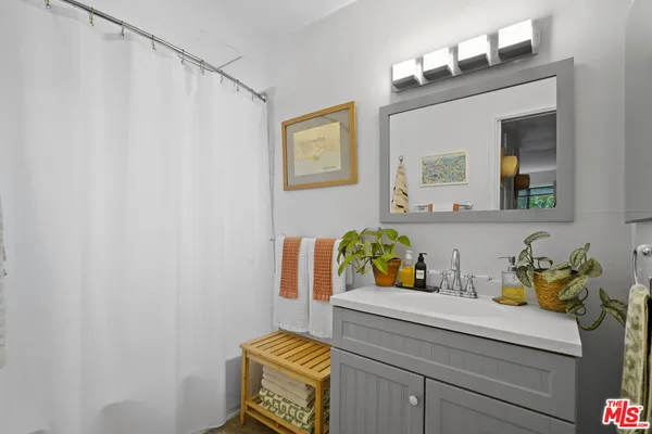 a bathroom with a sink mirror and vanity