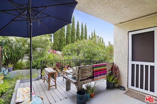 an outdoor space with furniture and umbrella