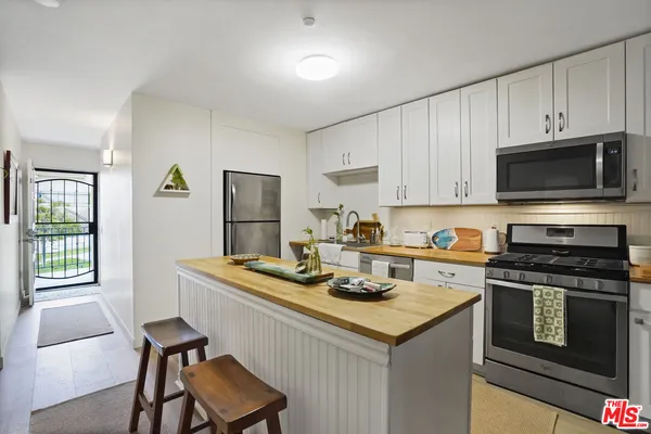 a kitchen with a stove a sink and a microwave