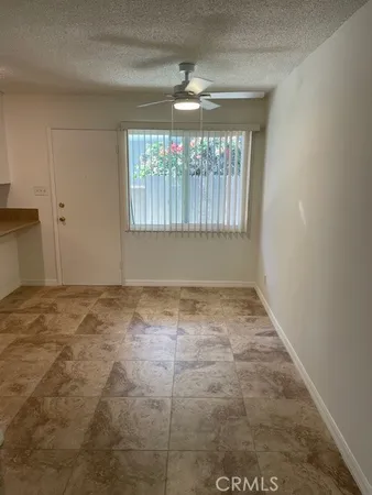 a bathroom with a toilet and a window