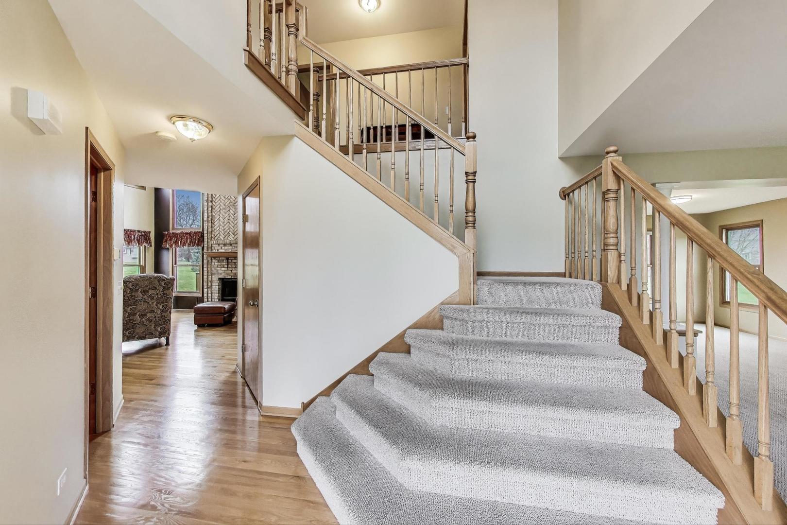 1606 Beech Street Spring Grove, IL 60081 - Photo 3 of 59 a view of staircase with lots of frames and a rug