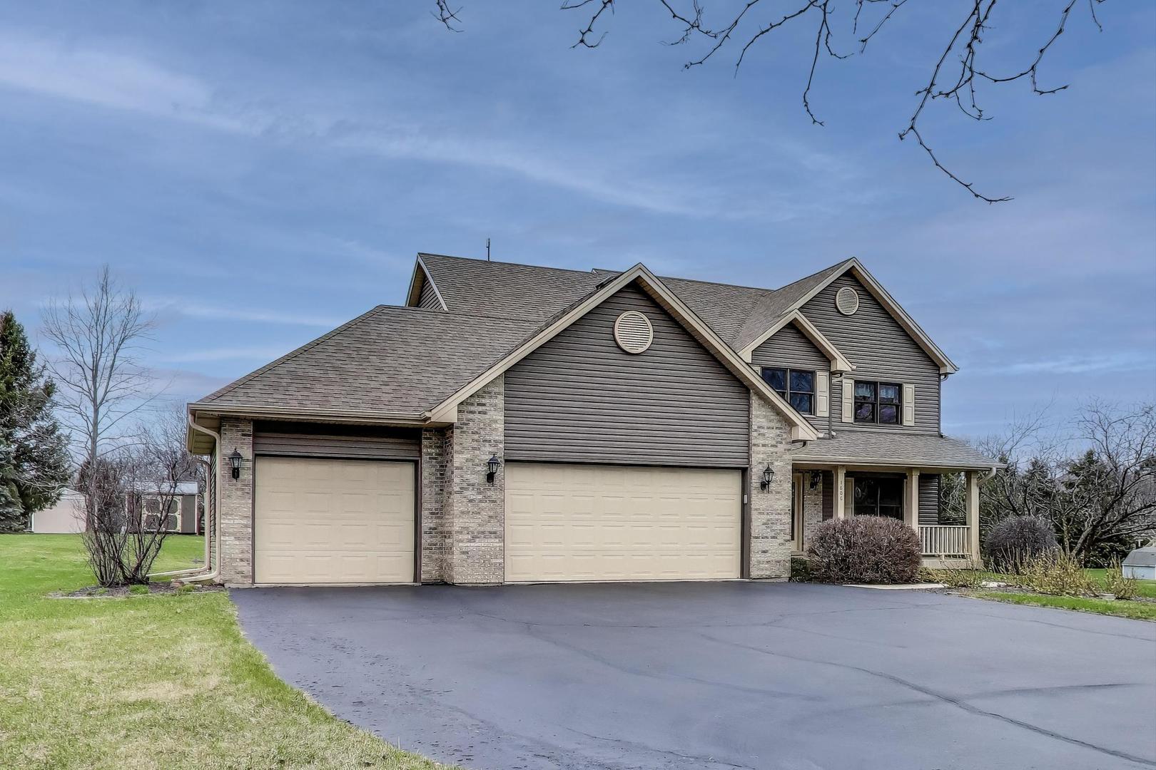 1606 Beech Street Spring Grove, IL 60081 - Photo 51 of 59 a front view of a house with a yard and garage