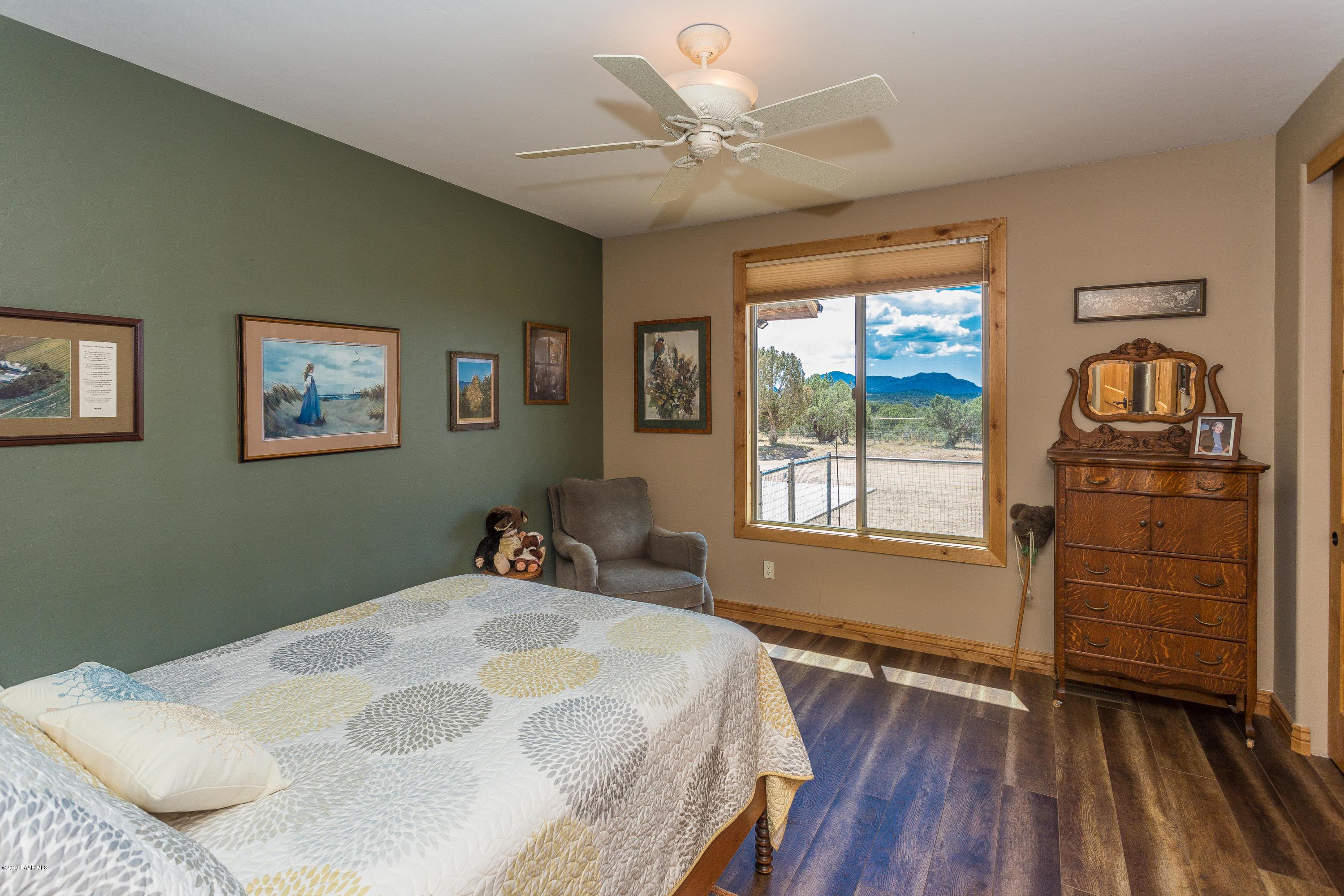 7301 Dillon Wash Road Prescott, AZ 86305 - Photo 11 of 36 a bedroom with a bed and wooden floor