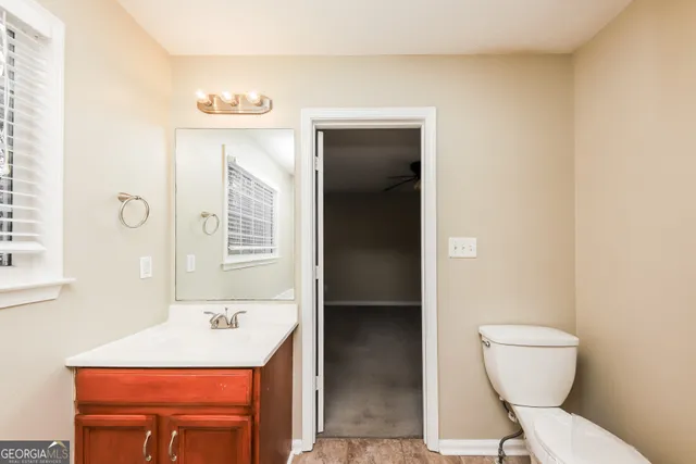 a bathroom with a sink a toilet and mirror