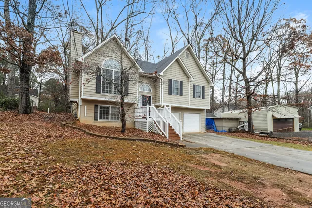 a view of a house with a large tree