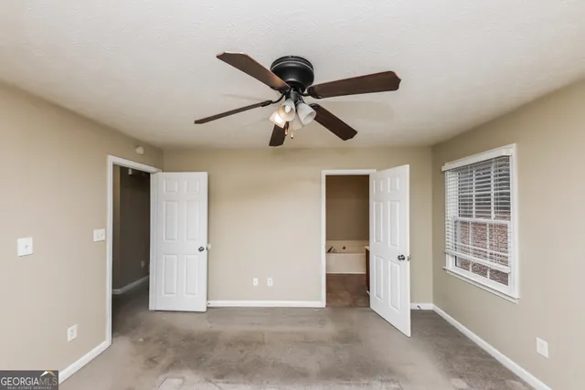 a view of room with a ceiling fan