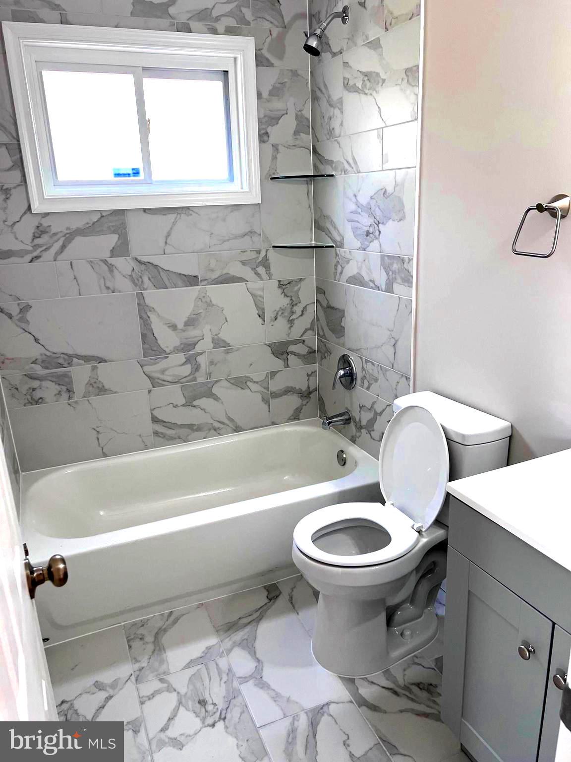 708 Crabb Avenue Rockville, MD 20850 - Photo 12 of 24 a bathroom with a toilet and a bathtub