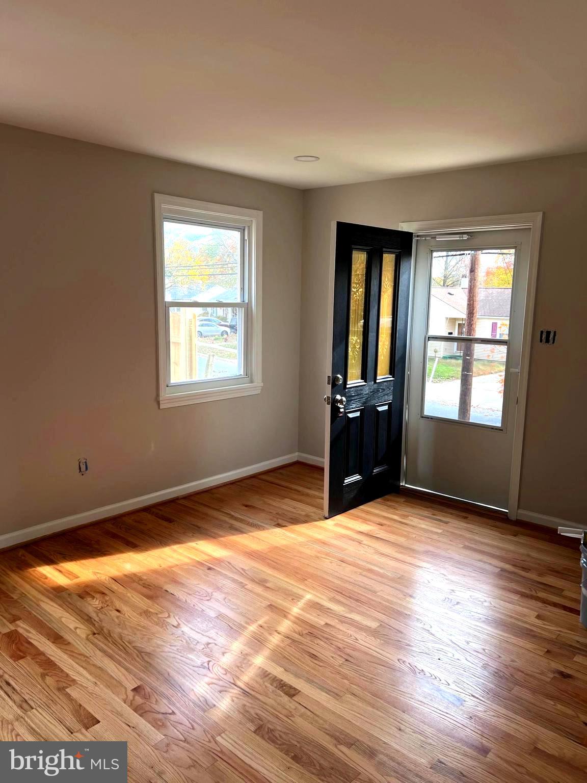 708 Crabb Avenue Rockville, MD 20850 - Photo 3 of 24 a view of an empty room with wooden floor and a window
